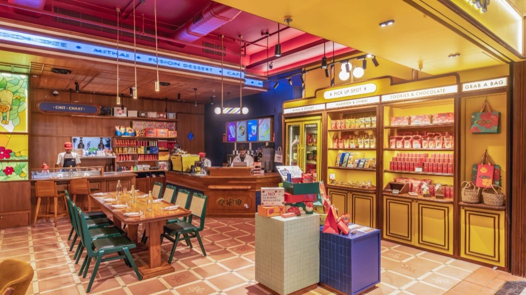 Wide view of retail yellow wall, communal table, and service counter
