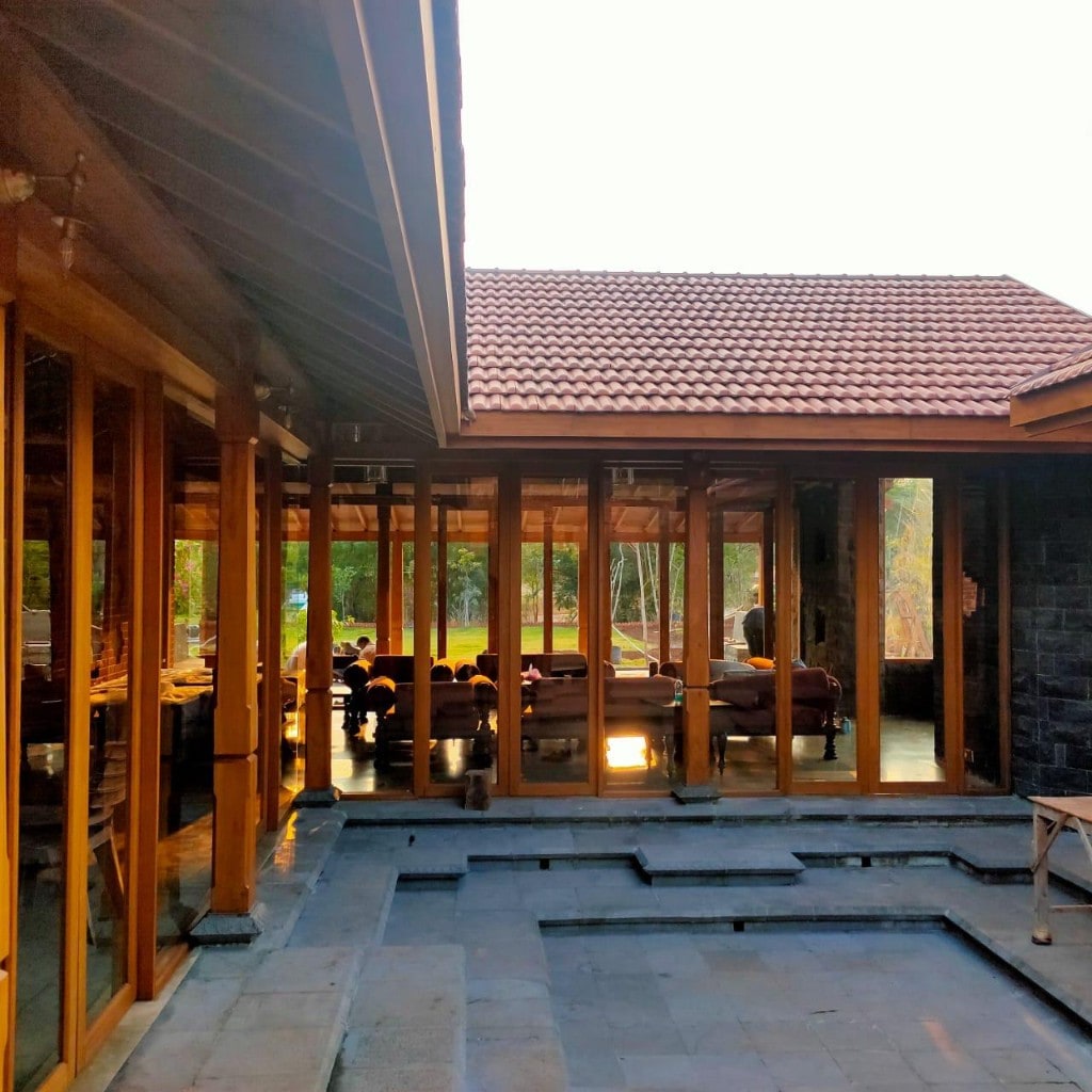 Courtyard and terracotta-roof pavilion with glass walls