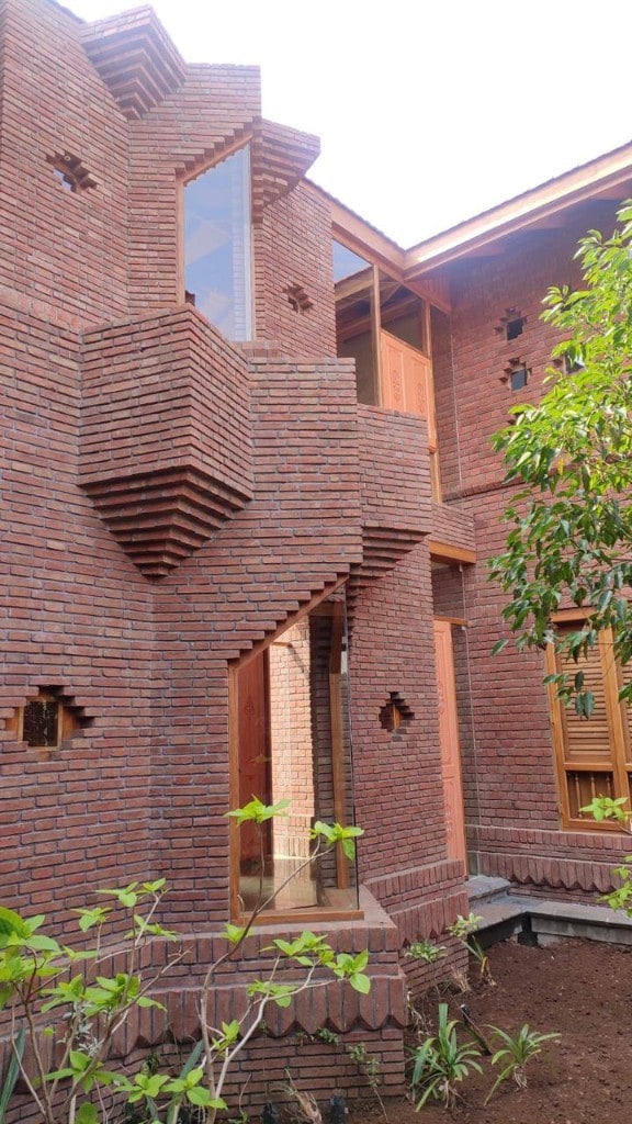 Geometric red-brick facade with carved openings